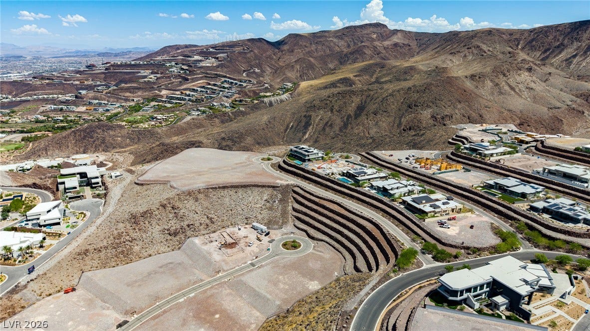 2 Epic View Court, Henderson, NV 89012 Dramatic mountain ridges frame terraced home sites overlooking a distant desert valley.