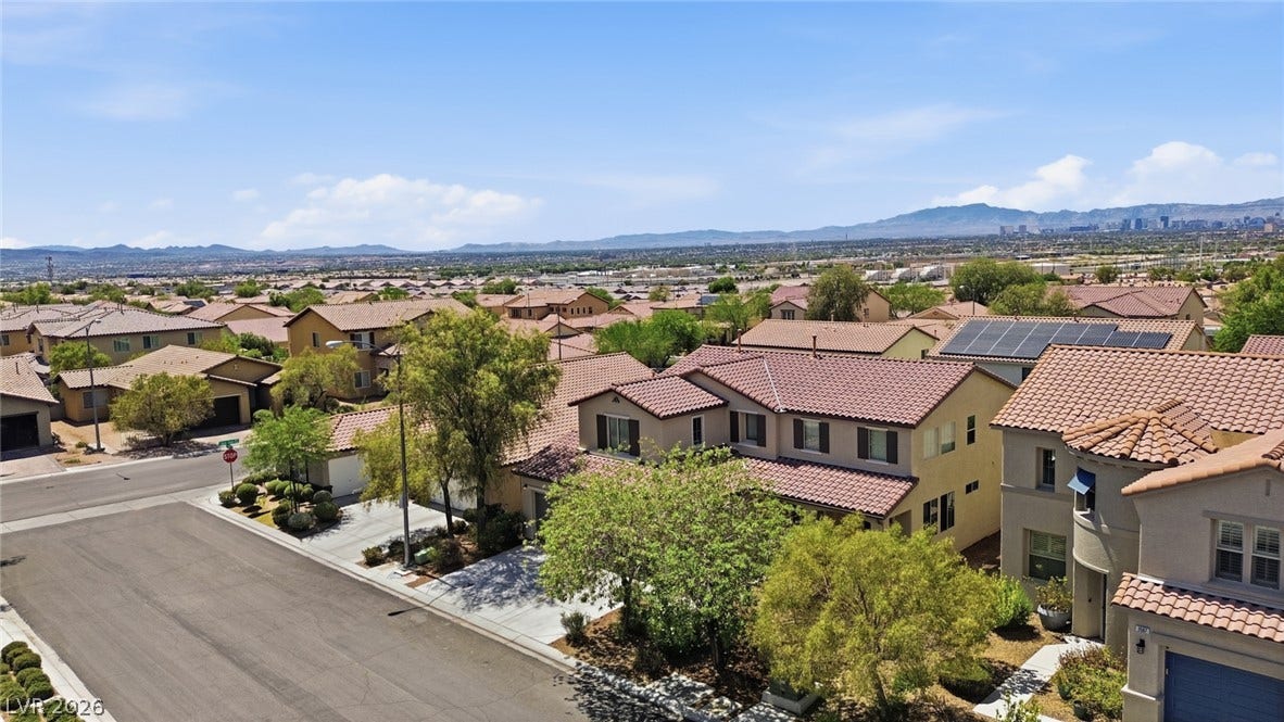 2607 Fading Night Court, Las Vegas, NV 89142 Distant mountain ranges border this suburban neighborhood of tile-roofed homes under clear blue skies.