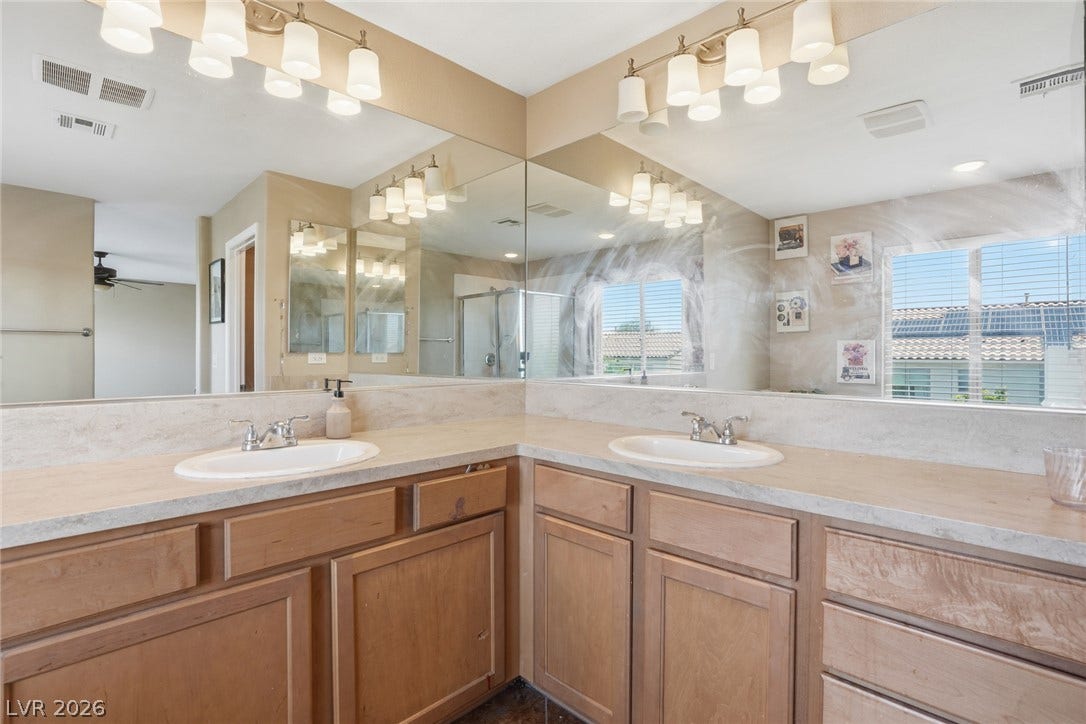2607 Fading Night Court, Las Vegas, NV 89142 An expansive corner vanity with dual sinks anchors this spacious washroom layout.