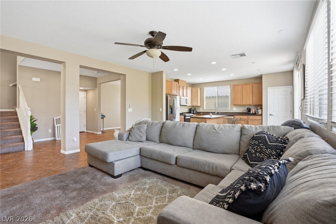 2607 Fading Night Court, Las Vegas, NV 89142 An open-concept living area flows seamlessly into the kitchen, illuminated by natural light through large windows.