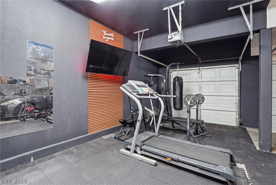 2607 Fading Night Court, Las Vegas, NV 89142 Dark walls and durable rubber mat flooring define this highly functional home gym setup.