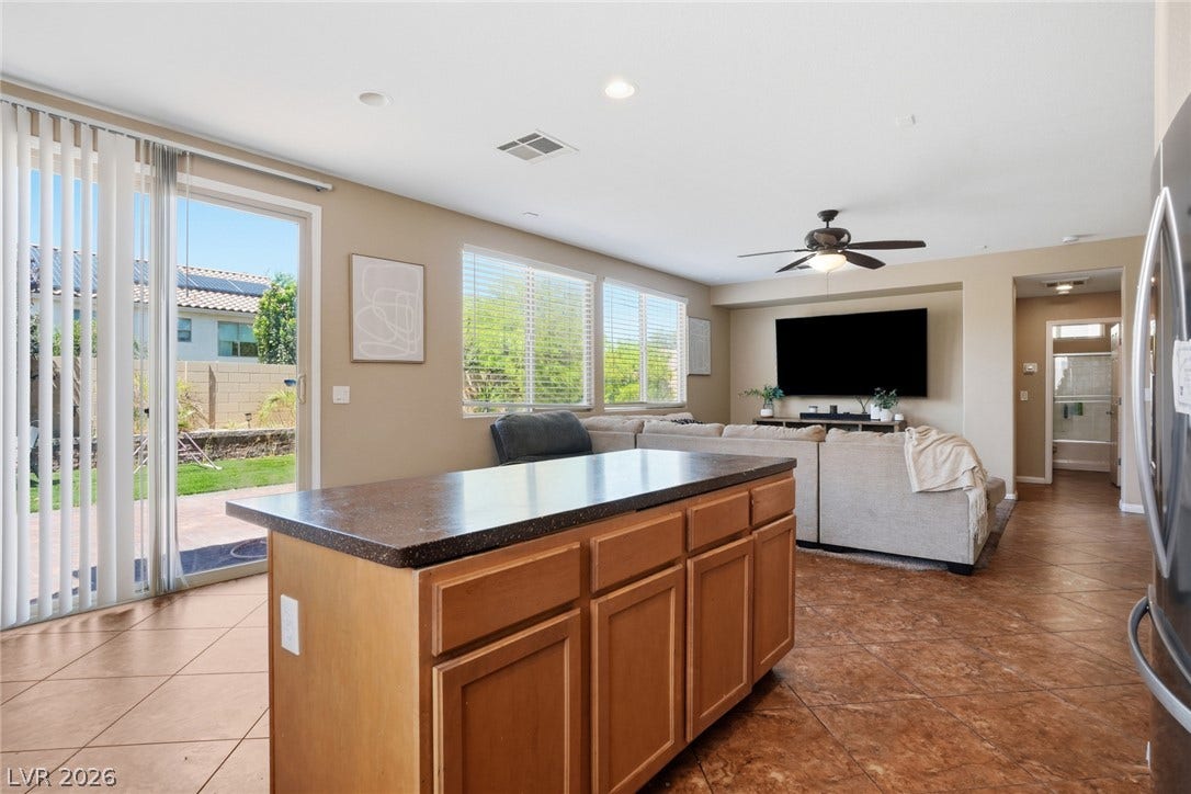 2607 Fading Night Court, Las Vegas, NV 89142 Sliding glass doors open from the tiled living area to the backyard.