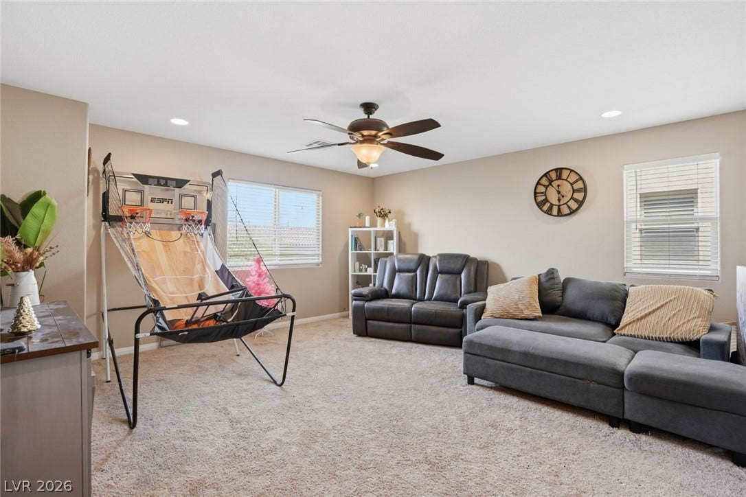 2607 Fading Night Court, Las Vegas, NV 89142 Plush carpeting anchors this versatile living space illuminated by recessed lighting.