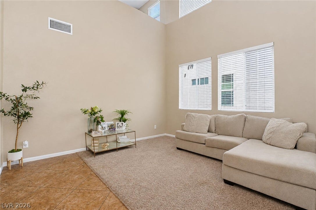 2607 Fading Night Court, Las Vegas, NV 89142 High vaulted ceilings and ample window light define this open living space with tile accents.