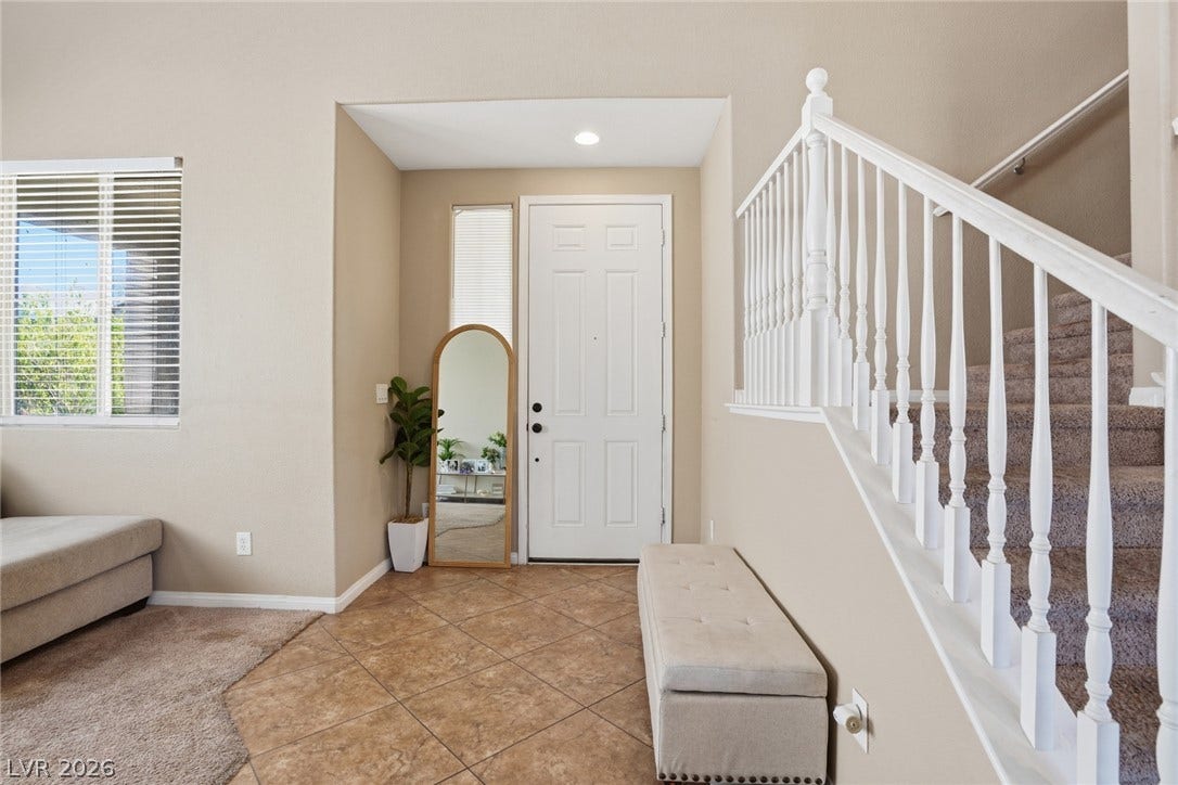 2607 Fading Night Court, Las Vegas, NV 89142 Tiled flooring and carpeted stairs define this welcoming entryway.