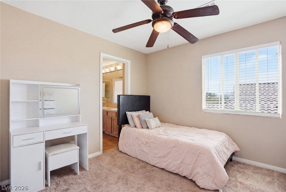 2607 Fading Night Court, Las Vegas, NV 89142 Plush carpeting anchors this comfortable bedroom complete with an attached bathroom suite.