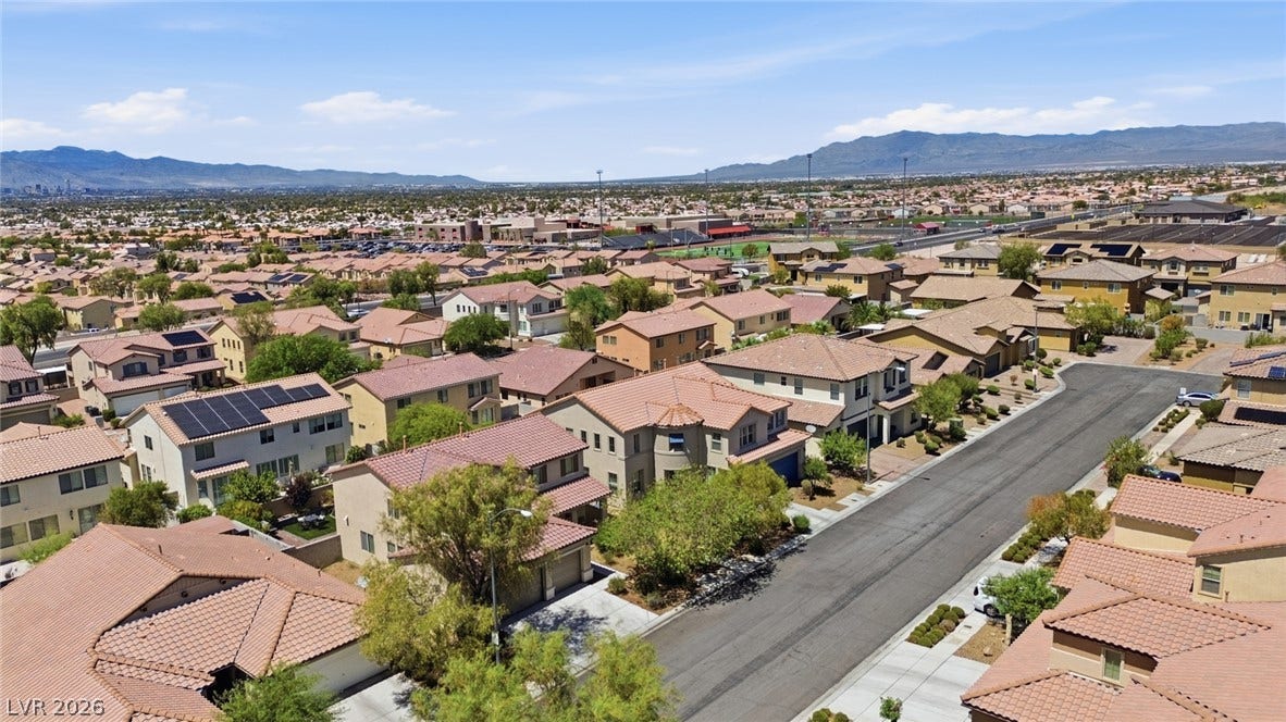 2607 Fading Night Court, Las Vegas, NV 89142 Quiet neighborhood streets wind through a peaceful residential community set against a distant mountain backdrop.