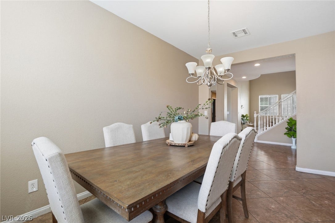 2607 Fading Night Court, Las Vegas, NV 89142 An open doorway connects the dining area with neutral tile floors to adjacent living spaces.