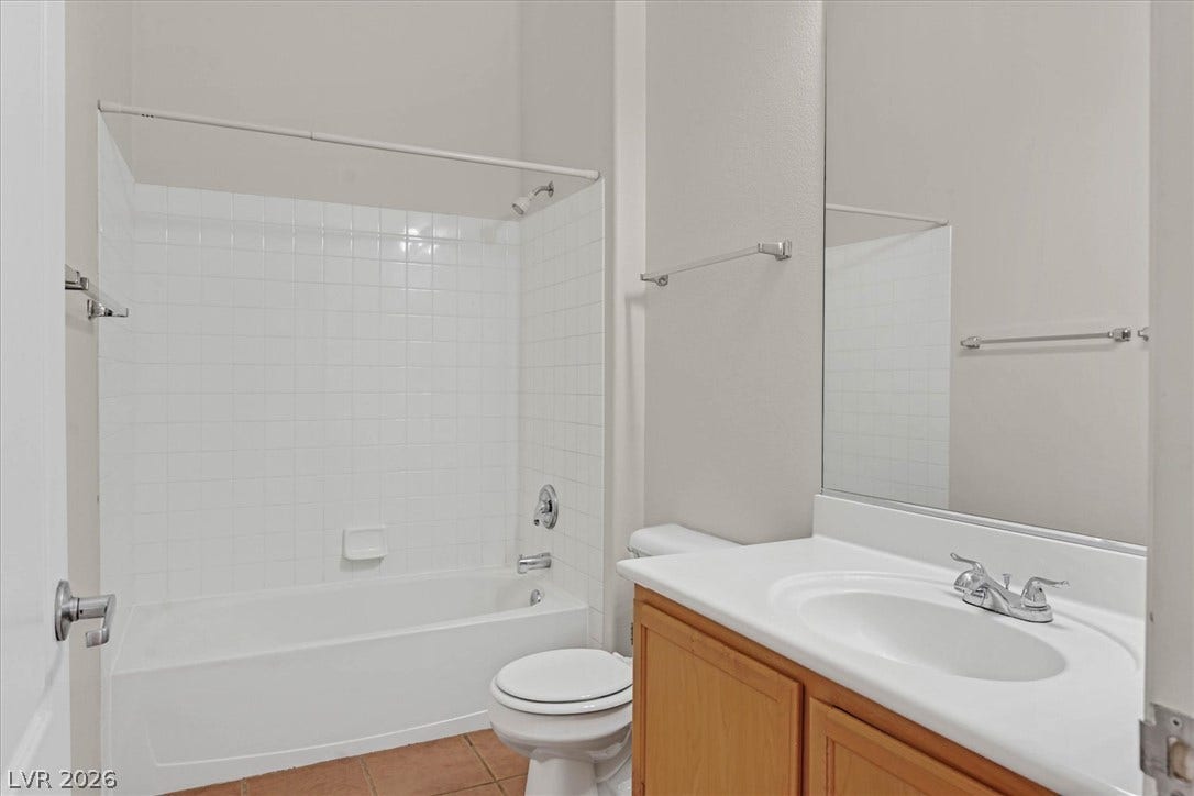 700 Carnegie Street, #2924, Henderson, NV 89052 Crisp tiled walls and a neutral vanity define this classic secondary bathroom.