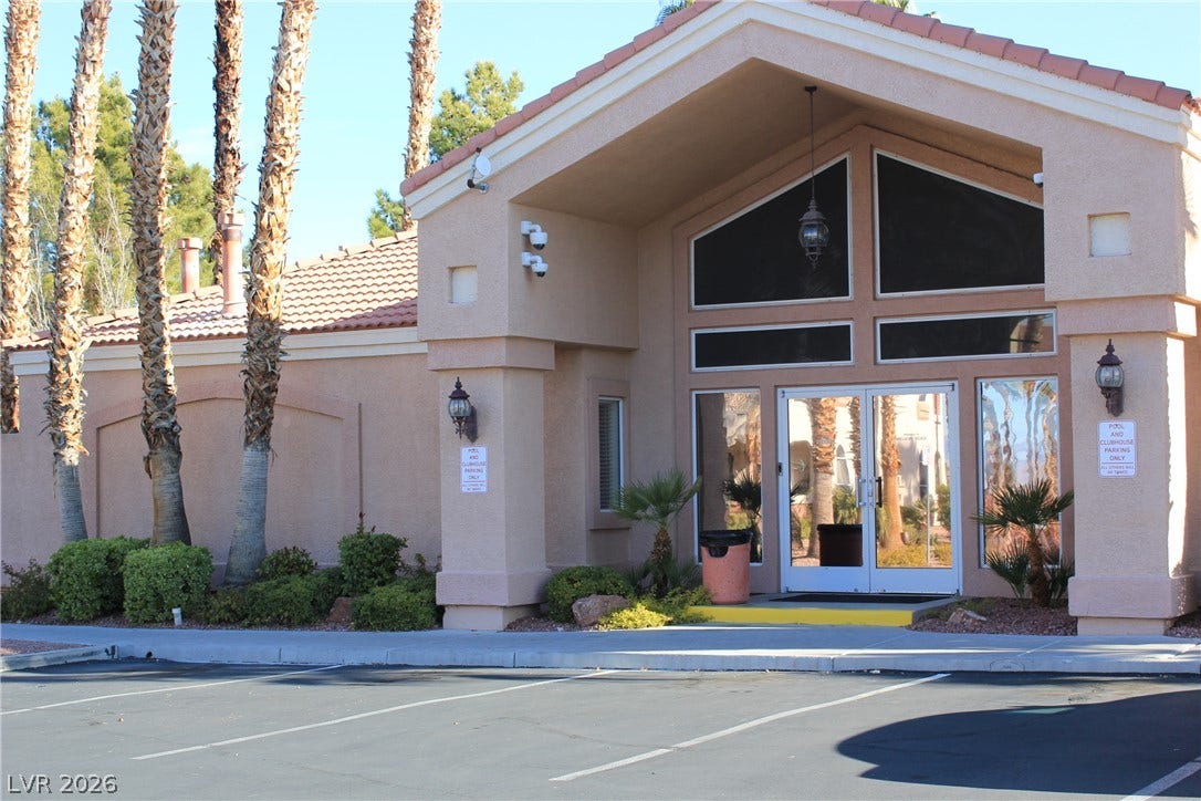 700 Carnegie Street, #2924, Henderson, NV 89052 Spanish tile roofing and grand double doors define this stucco entryway facing paved parking.