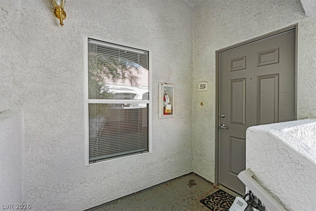 700 Carnegie Street, #2924, Henderson, NV 89052 An inviting entryway presents textured stucco walls and a classic paneled front door.