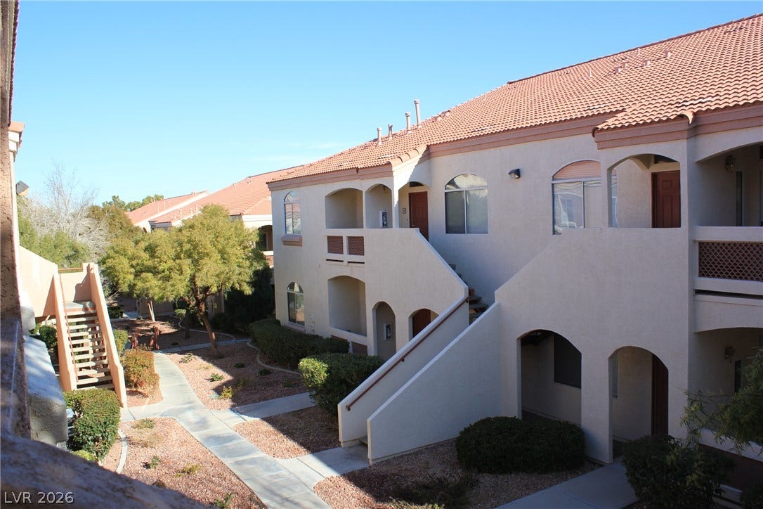 700 Carnegie Street, #2924, Henderson, NV 89052 Spanish tile roofs and stucco walls define this multi-level residential exterior.