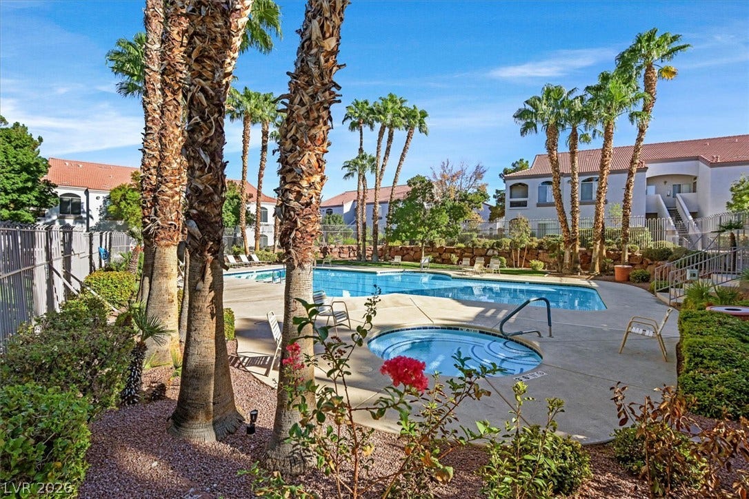 700 Carnegie Street, #2924, Henderson, NV 89052 Towering palm trees frame a shimmering swimming pool and spa area.