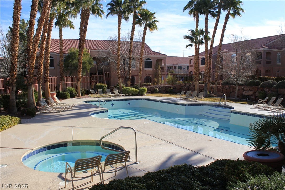 700 Carnegie Street, #2924, Henderson, NV 89052 Palm trees frame the shared swimming pool and spa adjacent to the multi-family residential structures.