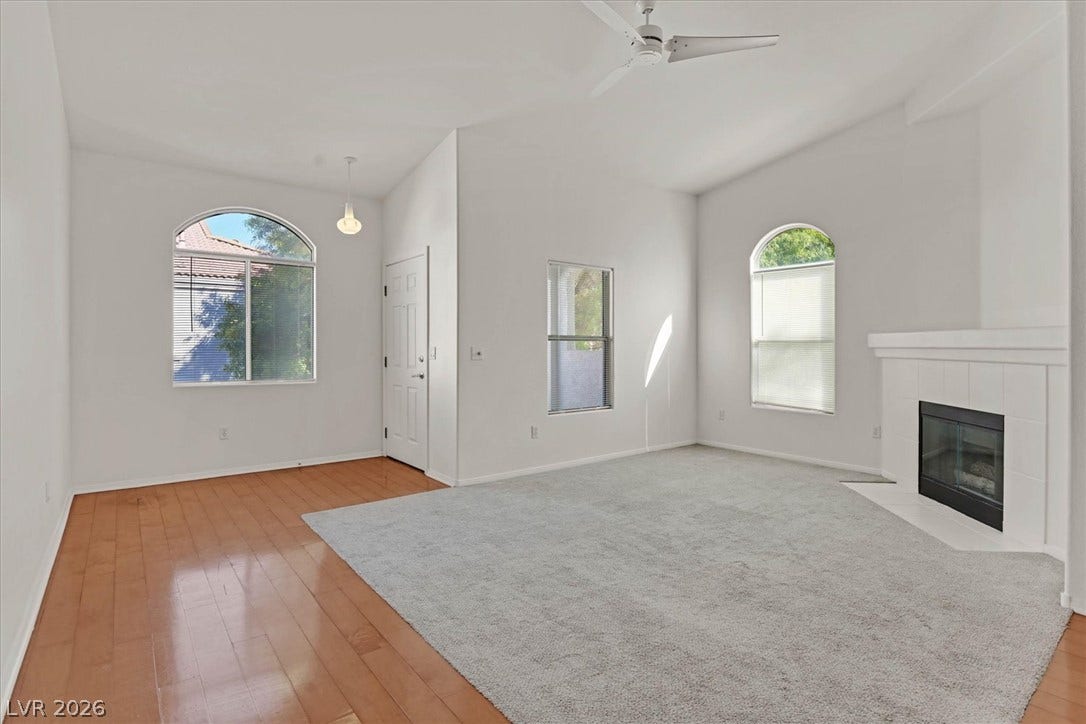 700 Carnegie Street, #2924, Henderson, NV 89052 An inviting fireplace and arched windows anchor this airy living space with high ceilings.