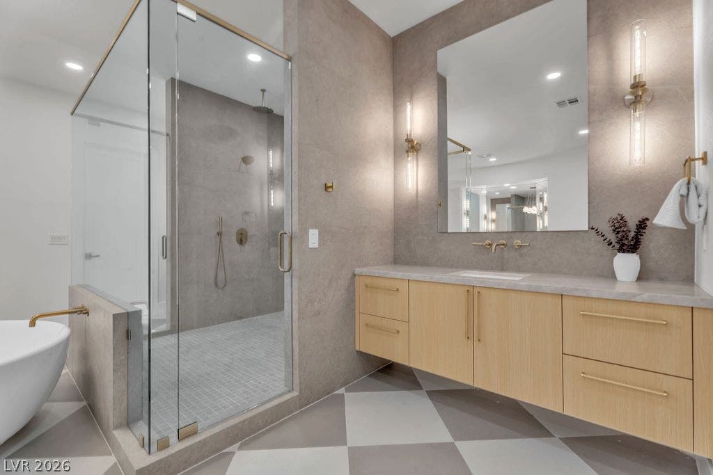 2690 Grassy Spring Place, Las Vegas, NV 89135 Patterned tile floors and a glass-enclosed shower highlight this modern primary bathroom.