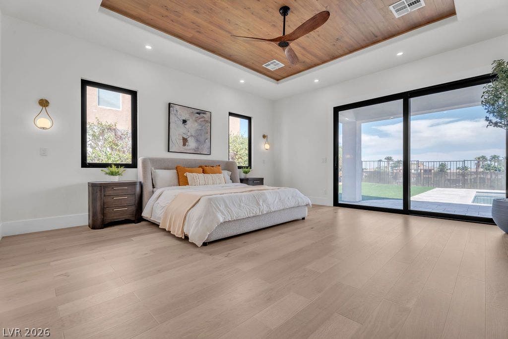 2690 Grassy Spring Place, Las Vegas, NV 89135 Sliding glass doors connect the light-filled bedroom to the backyard patio.