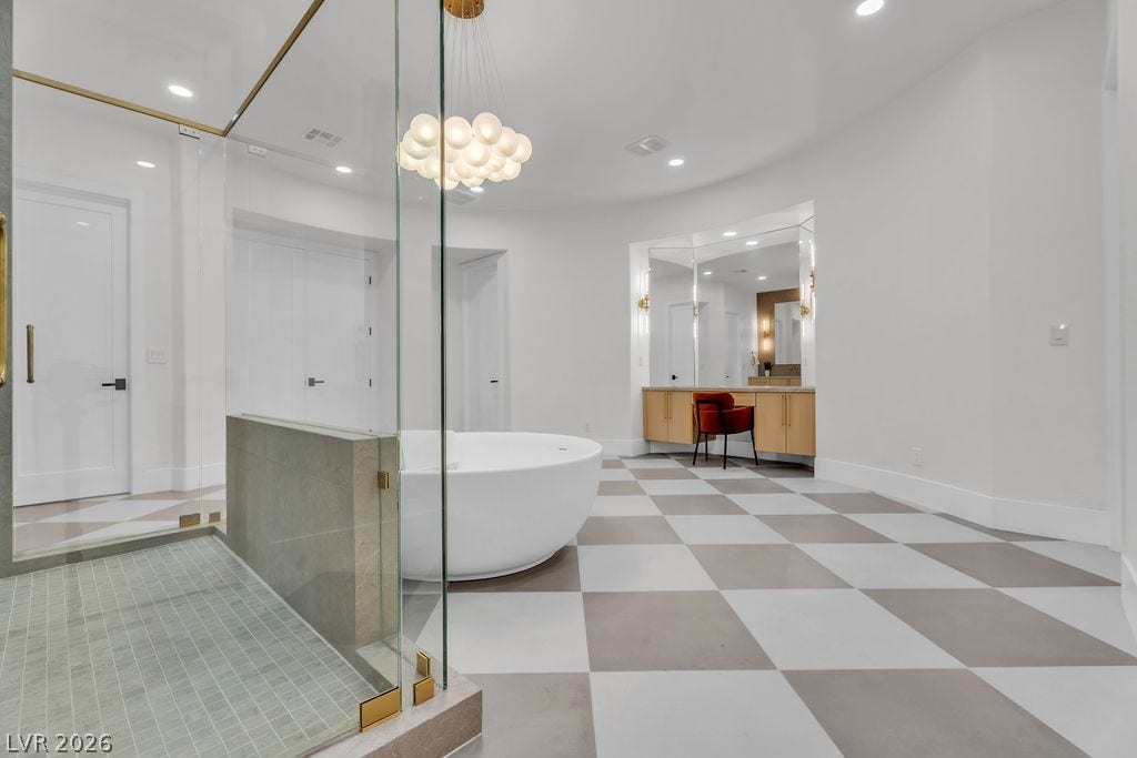 2690 Grassy Spring Place, Las Vegas, NV 89135 Checkerboard tile flooring anchors this modern washroom featuring a freestanding tub and glass shower enclosure.
