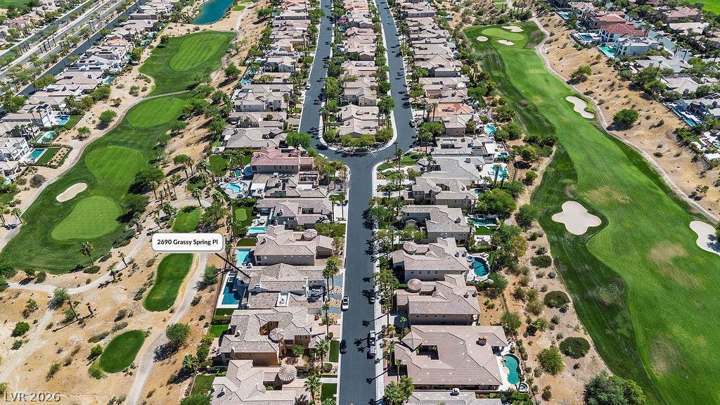 2690 Grassy Spring Place, Las Vegas, NV 89135 An aerial perspective showcases a quiet residential cul-de-sac bordered by expansive green golf fairways.