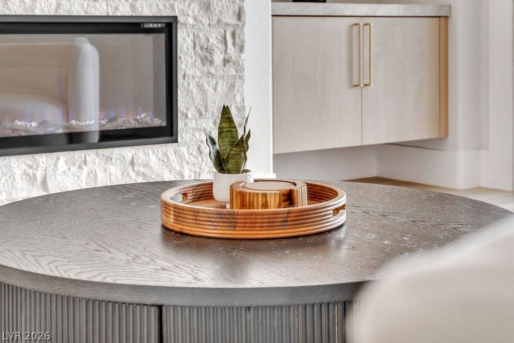 2690 Grassy Spring Place, Las Vegas, NV 89135 Textured white stone surrounds the modern linear fireplace next to custom built-in cabinetry.