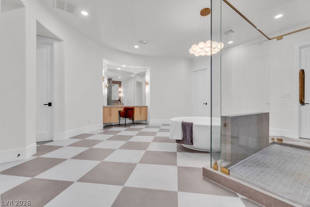 2690 Grassy Spring Place, Las Vegas, NV 89135 Checkerboard tile flooring anchors this modern washroom featuring a freestanding tub and glass shower.