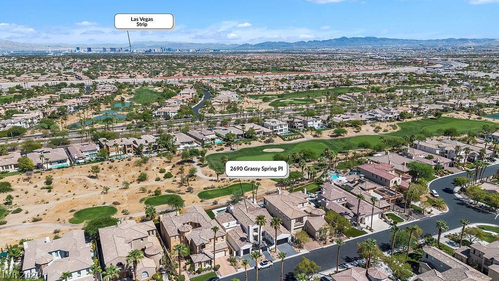 2690 Grassy Spring Place, Las Vegas, NV 89135 Aerial view showcases the sweeping valley and golf course panorama extending to the distant skyline.