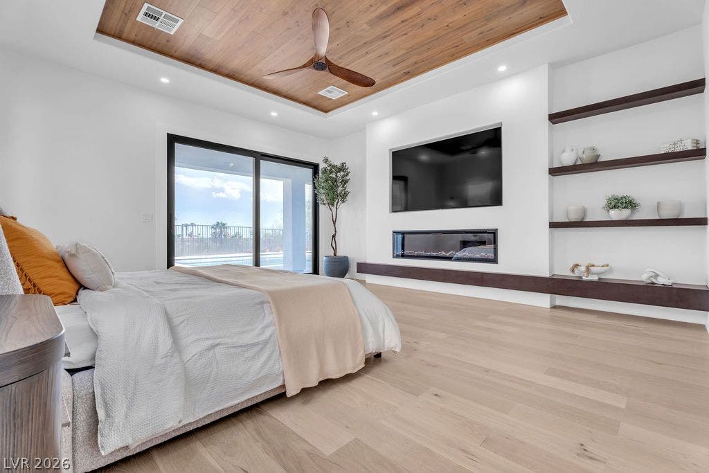 2690 Grassy Spring Place, Las Vegas, NV 89135 Rich wood ceiling panels and a linear fireplace enhance this modern bedroom suite.