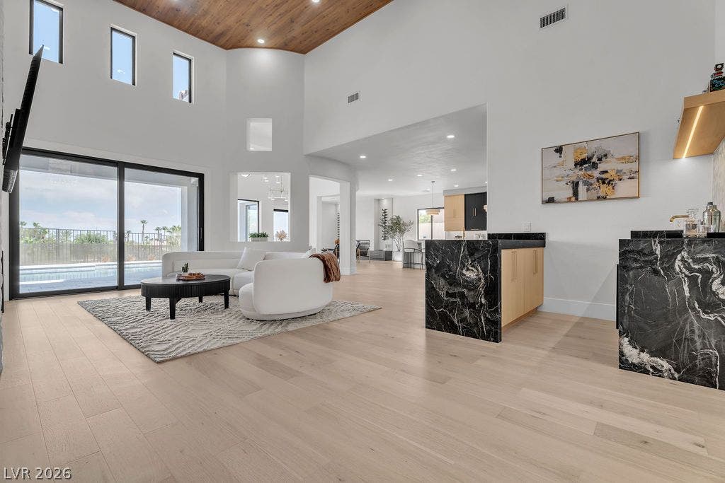2690 Grassy Spring Place, Las Vegas, NV 89135 High wood-clad ceilings and broad sliding glass doors frame this airy, open-concept living space.