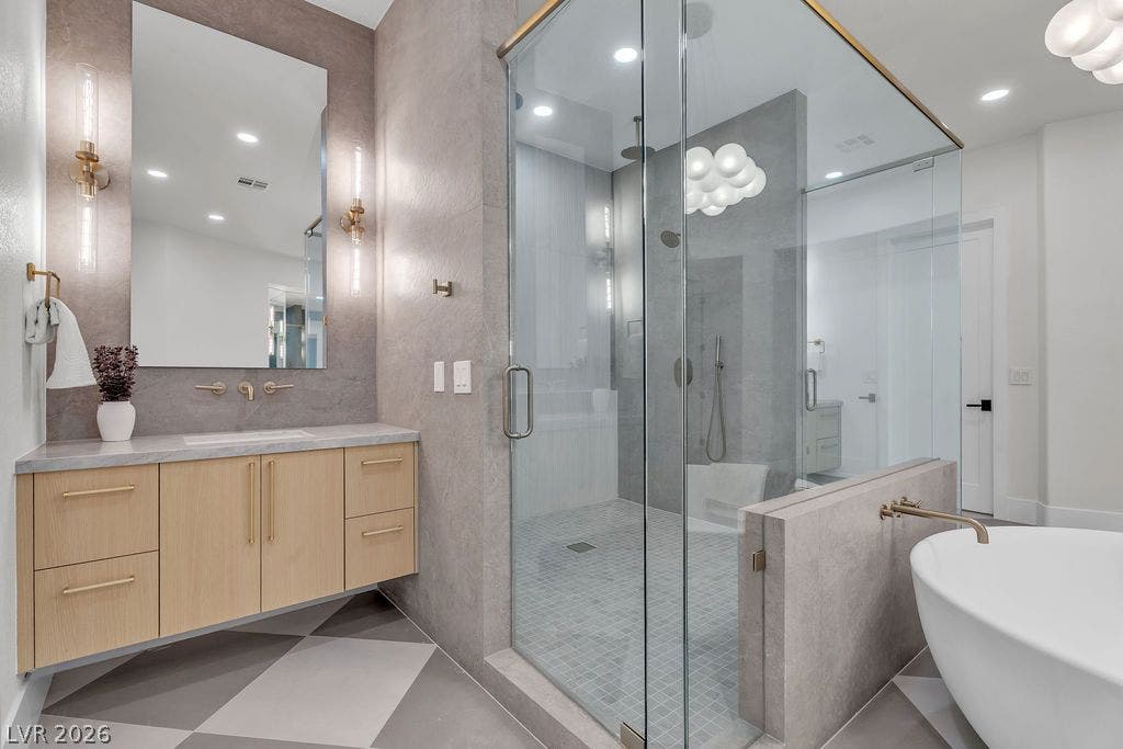 2690 Grassy Spring Place, Las Vegas, NV 89135 Geometric tile flooring and a glass-enclosed shower anchor this contemporary bathroom design.
