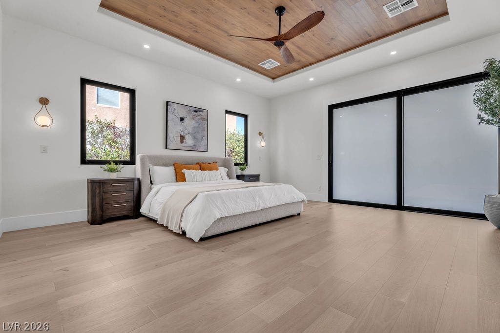 2690 Grassy Spring Place, Las Vegas, NV 89135 Rich wood details accent the tray ceiling above smooth hardwood flooring and sliding glass doors.