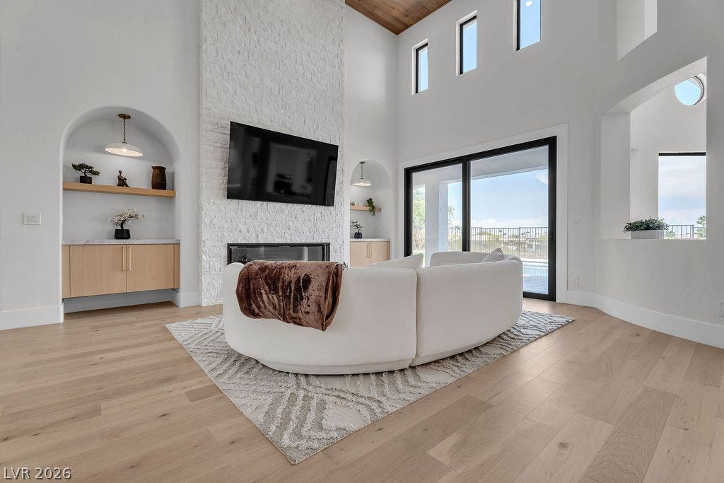 2690 Grassy Spring Place, Las Vegas, NV 89135 High wood-clad ceilings and a floor-to-ceiling stone fireplace anchor this airy living space.