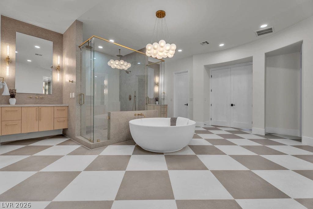 2690 Grassy Spring Place, Las Vegas, NV 89135 Checkerboard tile flooring anchors a luxurious bath featuring a freestanding tub and glass shower.