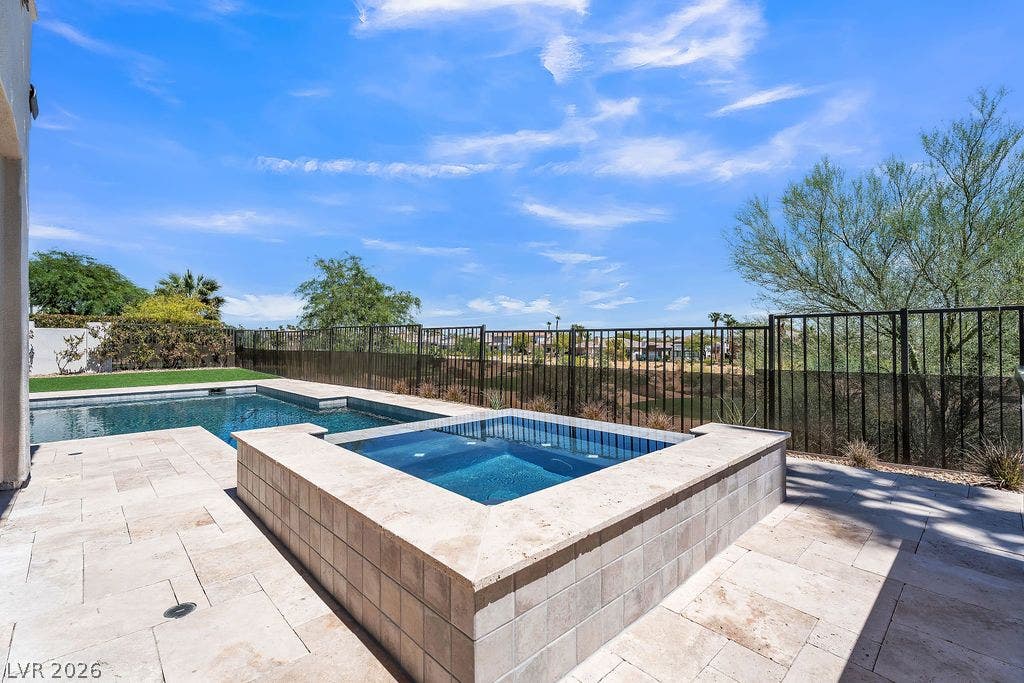 2690 Grassy Spring Place, Las Vegas, NV 89135 An inviting stone patio surrounds the sparkling pool and elevated spa under open desert skies.