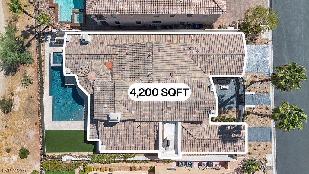 2690 Grassy Spring Place, Las Vegas, NV 89135 An aerial perspective showcases the expansive clay tile roofline and private backyard swimming pool.