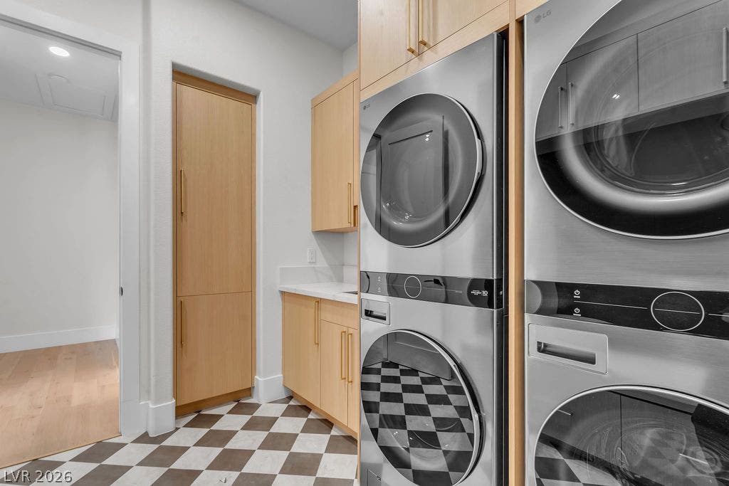 2690 Grassy Spring Place, Las Vegas, NV 89135 Checkerboard tile flooring and custom wood cabinetry define this functional utility space.