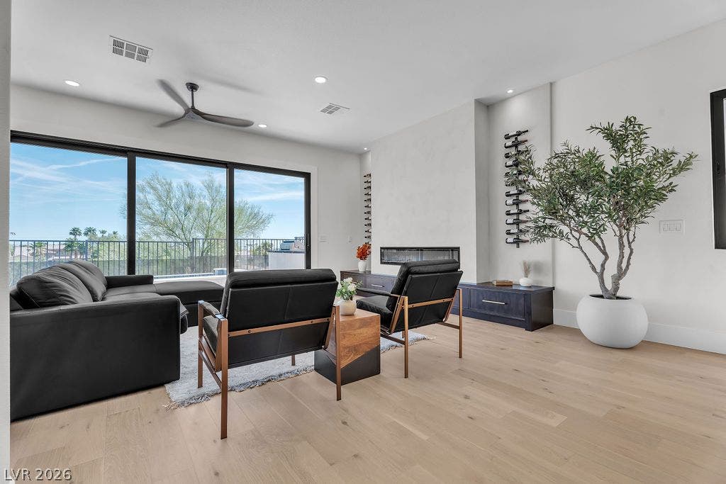 2690 Grassy Spring Place, Las Vegas, NV 89135 Massive sliding glass doors connect the living room to outdoor views.