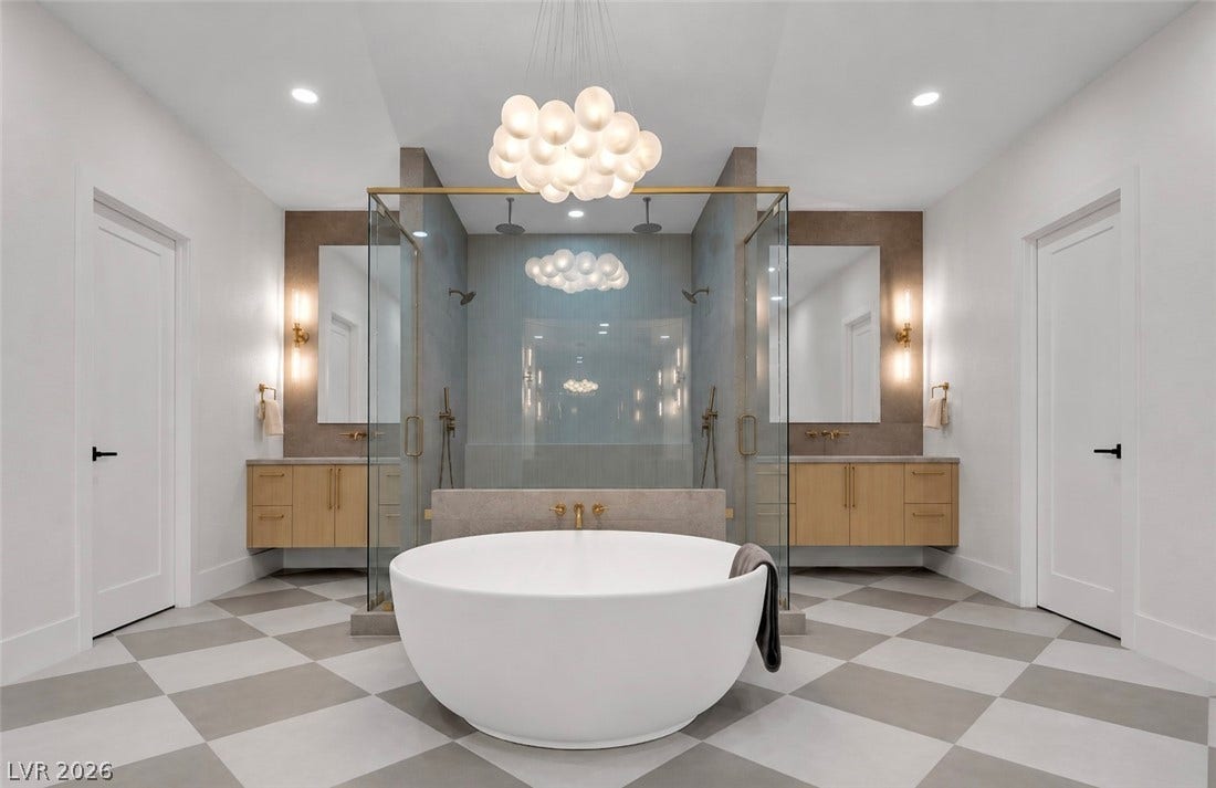 2690 Grassy Spring Place, Las Vegas, NV 89135 Geometric tiled flooring and a freestanding tub create a symmetrical primary bath sanctuary.