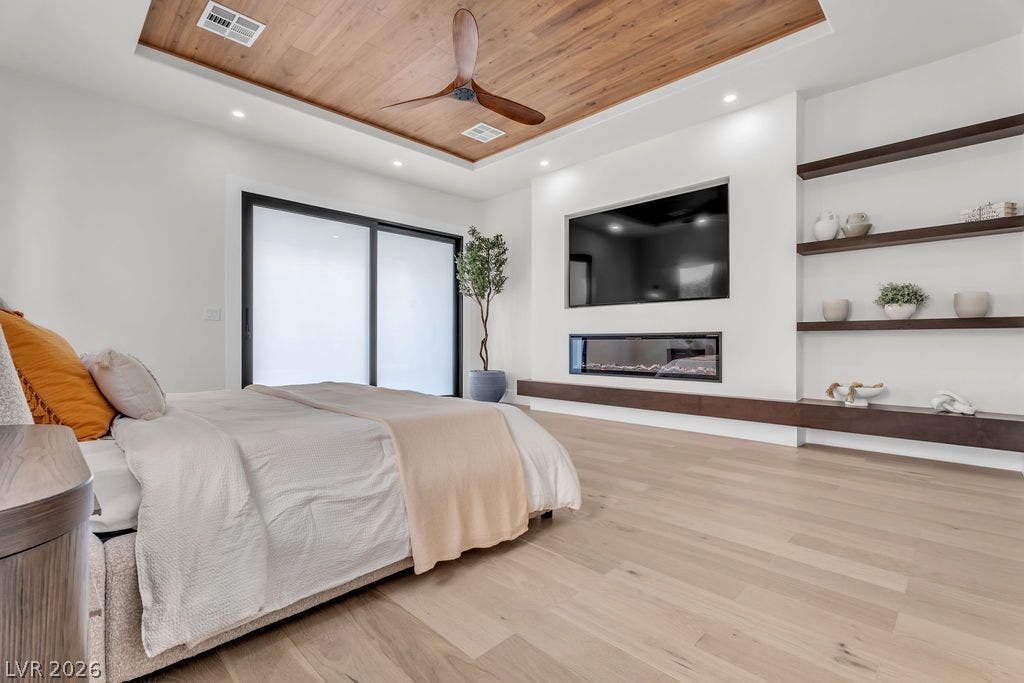 2690 Grassy Spring Place, Las Vegas, NV 89135 Warm wood ceiling accents and a sleek linear fireplace define this modern sleeping sanctuary.