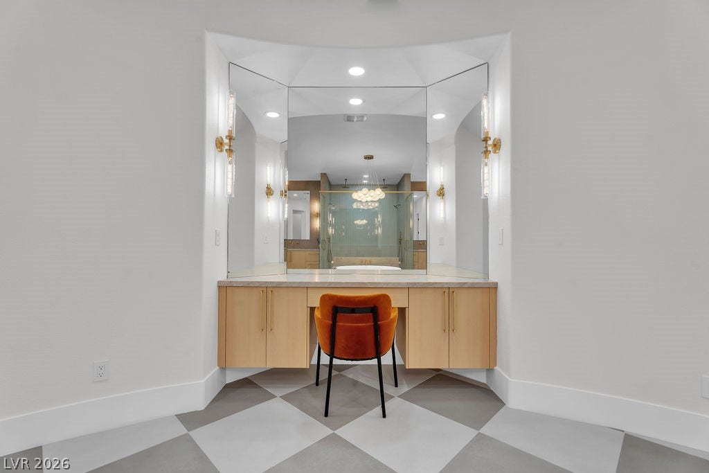 2690 Grassy Spring Place, Las Vegas, NV 89135 Geometric patterned tile floors anchor a built-in vanity alcove with an integrated triptych mirror.