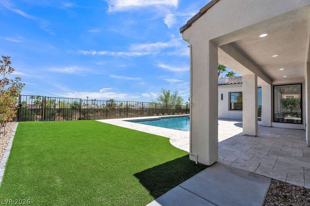 2690 Grassy Spring Place, Las Vegas, NV 89135 An inviting covered patio opens directly onto a manicured lawn and private swimming pool.