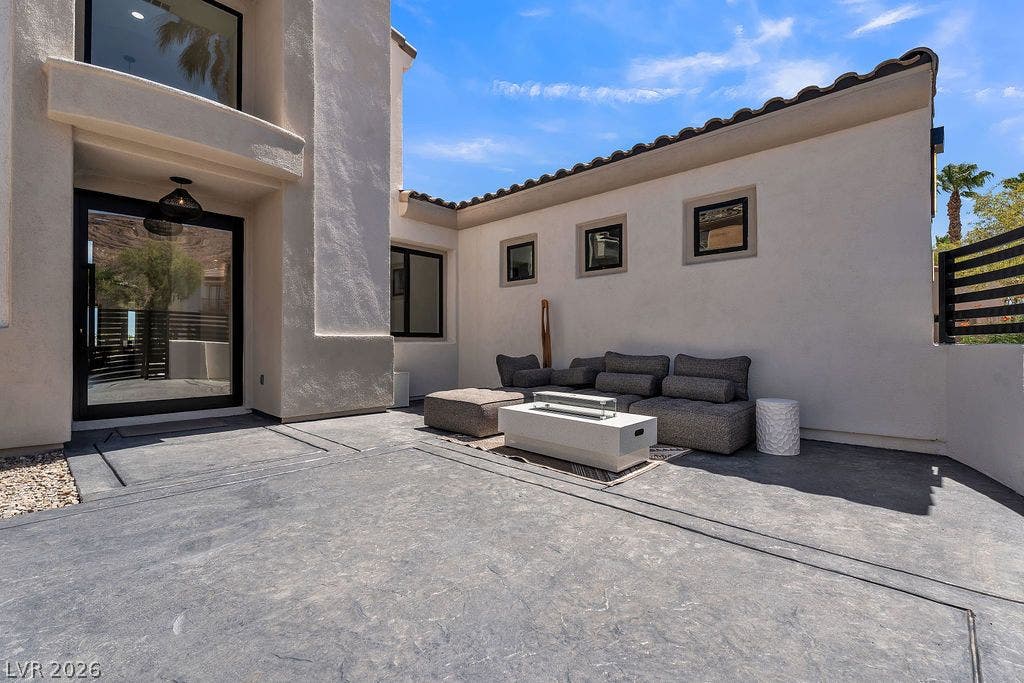2690 Grassy Spring Place, Las Vegas, NV 89135 Smooth stucco walls and tile roofing frame a spacious courtyard patio with textured concrete flooring.