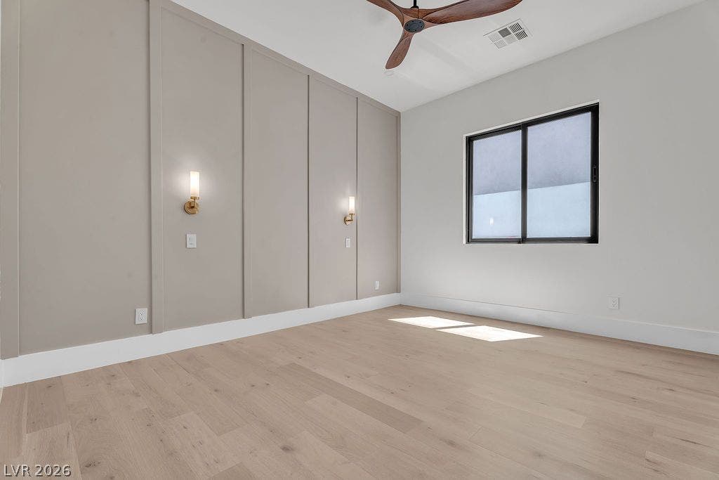 2690 Grassy Spring Place, Las Vegas, NV 89135 Elegant board and batten paneling defines this modern space with light hardwood floors.