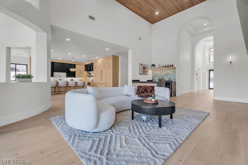 2690 Grassy Spring Place, Las Vegas, NV 89135 Warm wood ceiling panels and wide-plank flooring anchor this airy, open-concept living space.