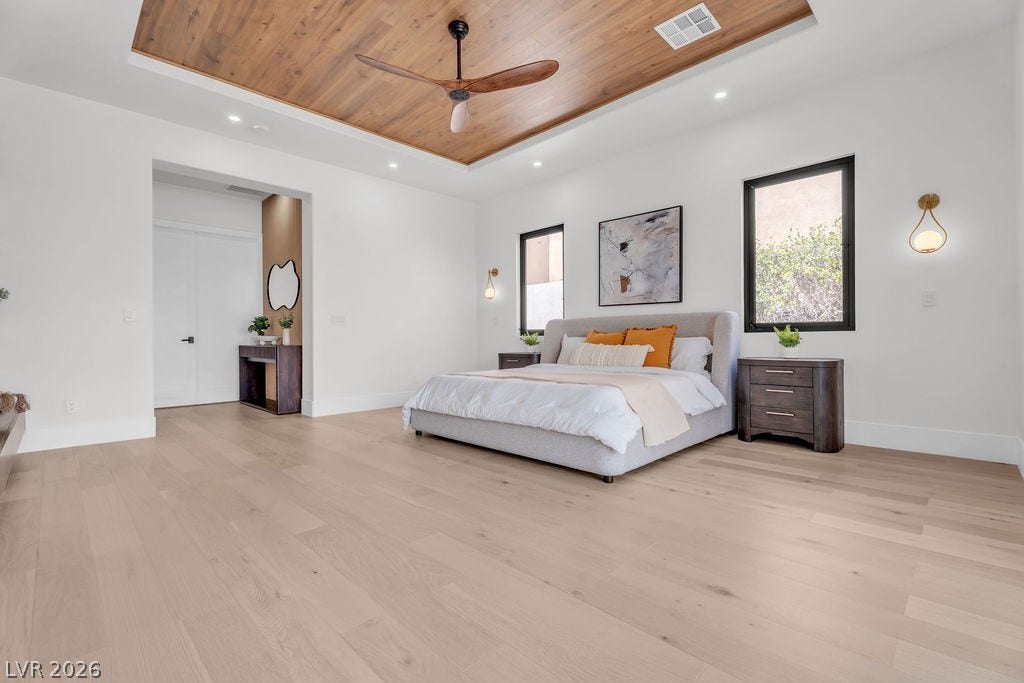 2690 Grassy Spring Place, Las Vegas, NV 89135 Rich wood inlays accent the tray ceiling above wide-plank hardwood floors in this suite.