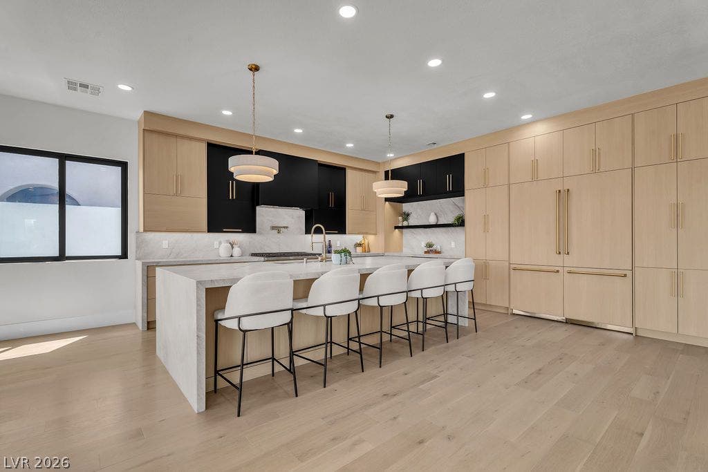 2690 Grassy Spring Place, Las Vegas, NV 89135 Hardwood floors and built-in cabinetry define this open kitchen featuring a waterfall island.