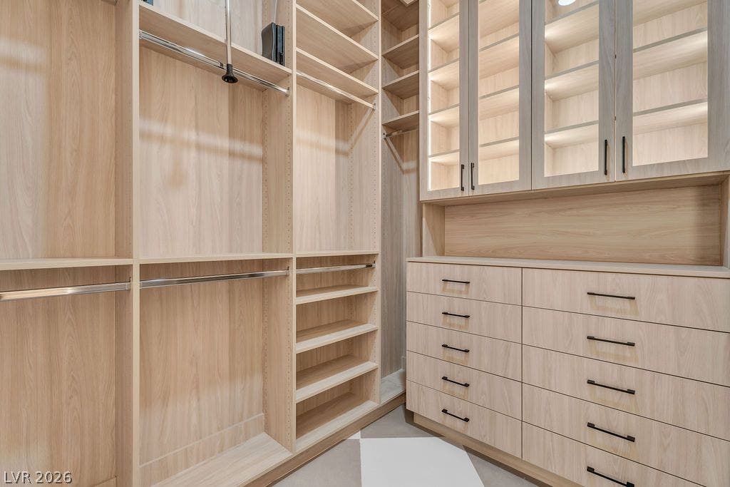 2690 Grassy Spring Place, Las Vegas, NV 89135 Custom built-in cabinetry provides abundant storage within this spacious wardrobe room.