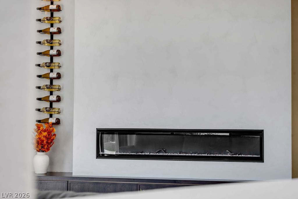 2690 Grassy Spring Place, Las Vegas, NV 89135 A modern linear fireplace serves as a striking centerpiece set into a textured plaster wall.
