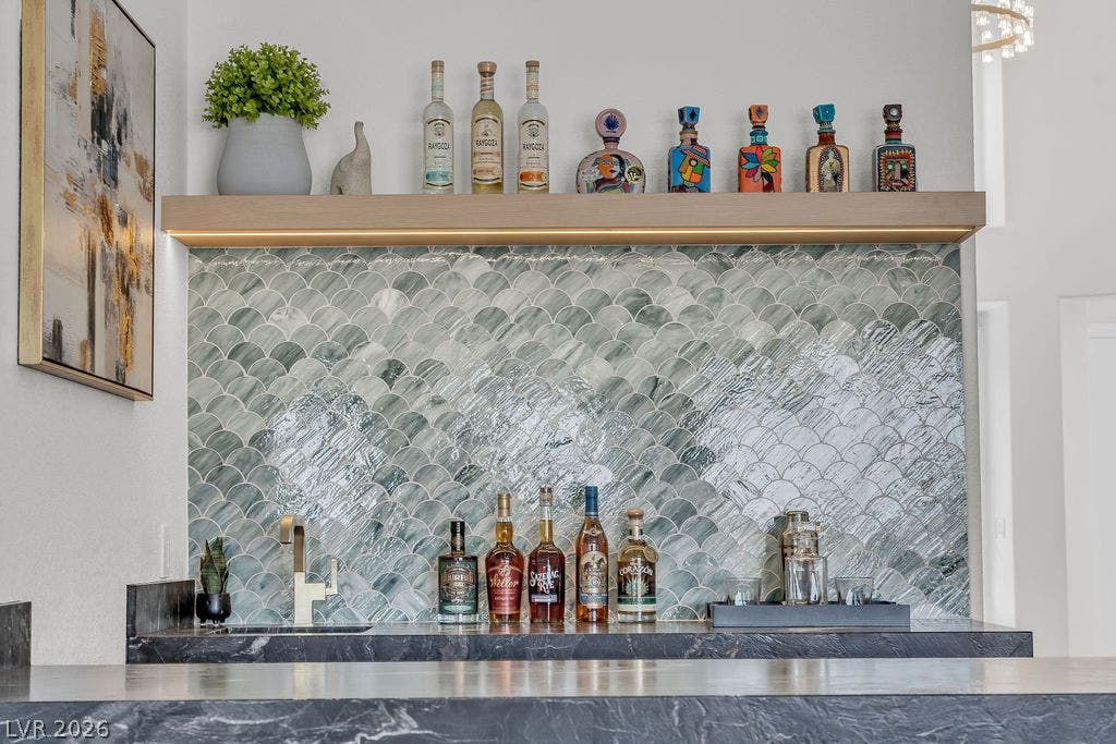 2690 Grassy Spring Place, Las Vegas, NV 89135 Custom tiled backsplash and premium stone countertops define this elegant home wet bar.