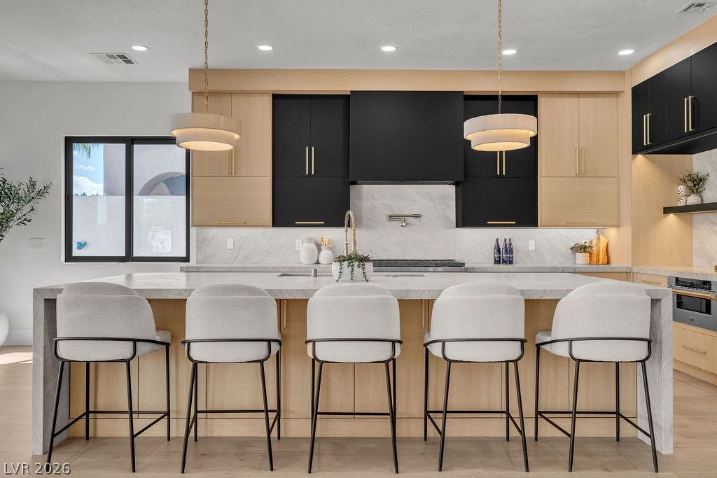 2690 Grassy Spring Place, Las Vegas, NV 89135 Custom cabinetry and stone countertops anchor this contemporary culinary space.