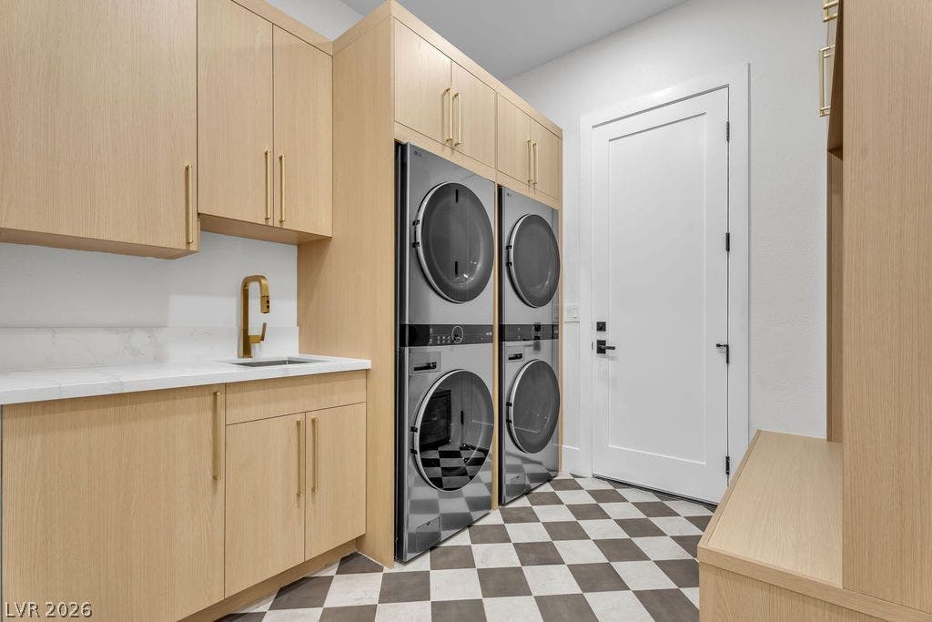 2690 Grassy Spring Place, Las Vegas, NV 89135 Custom oak cabinetry and patterned tile floors define this functional laundry room.